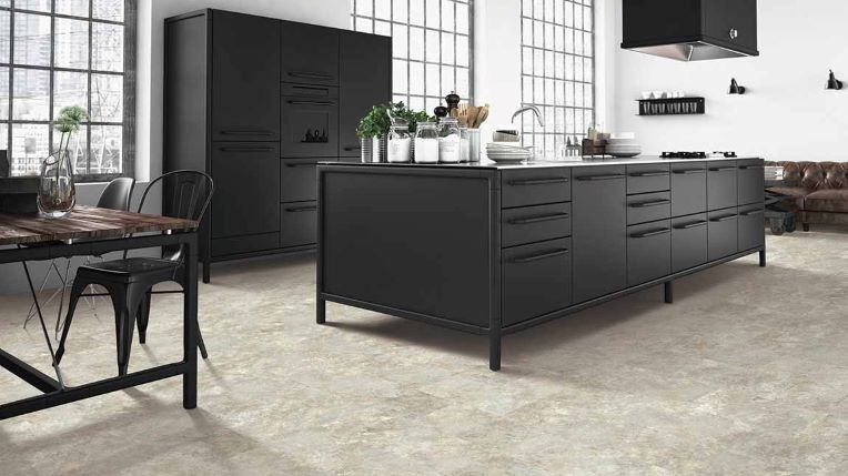 Luxury vinyl tile flooring in a modern black and white kitchen